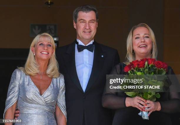 Bavaria's State Premier Markus Soeder, his wife Karin Soeder and Katharina Wagner, great-granddaughter of German composer Richard Wagner, pose as...