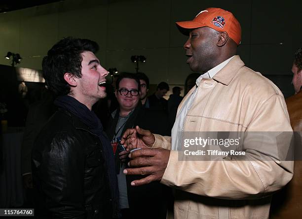 Joe Jonas of Jonas Brothers and actor Michael Clarke Dunken attend GBK's BCS National Championship Gift Lounge at Pasadena Convention Center on...