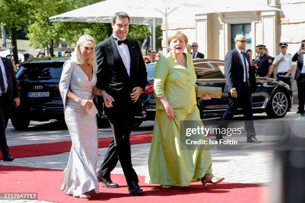 Karin Baumueller and her husband German politician Markus Soeder and German Federal Chancellor Angela Merkel, during the Bayreuth Festival 2019...