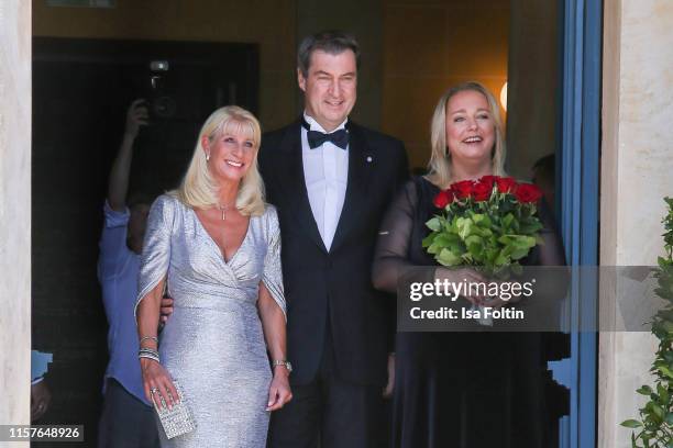 Karin Baumueller with her husband German politician Markus Soeder and Katharina Wagner during the Bayreuth Festival 2019 opening premiere...