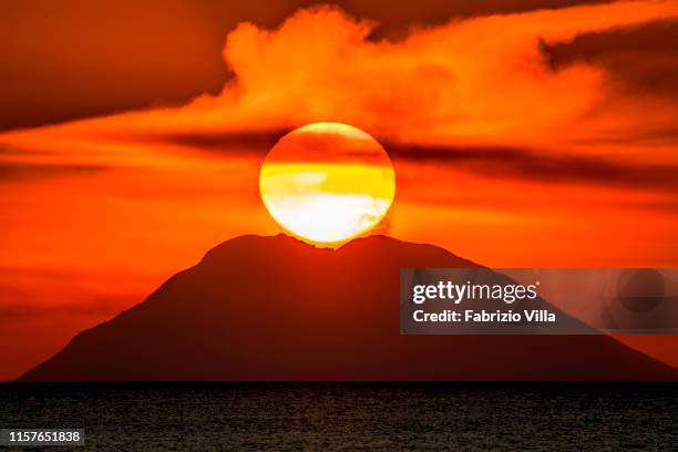 Sunset over the Stromboli Volcano, a candidate for UNESCO World Heritage Site status on July 25, 2019 in Vibo Valentia, Italy. The photograph was...