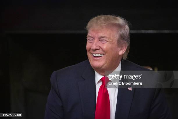 President Donald Trump laughs during the "Pledge to America's Workers" event at the White House in Washington, D.C., U.S., on Thursday, July 25,...