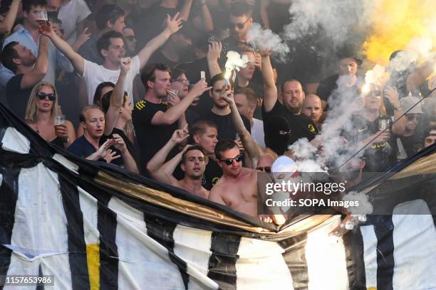 Supporters of AIK cheer for their team during the Second qualifying round of the UEFA Champions League between NK Maribor and AIK Football at the...