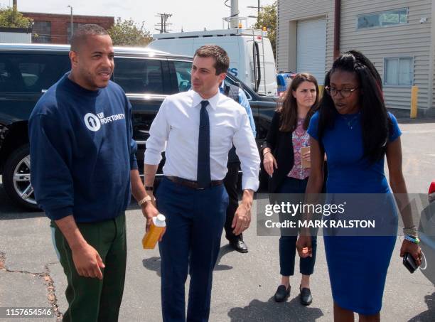 Democratic presidential hopeful and South Bend, Indiana mayor Pete Buttigieg is greeted by David Gross before his tour of the Vector 90 headquarters...