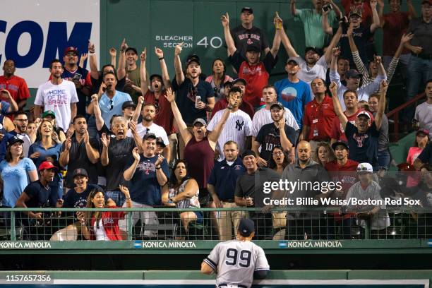Fans react as Aaron Judge watches a home run ball hit by Sandy Leon of the Boston Red Sox during the eighth inning of a game on July 25, 2019 at...