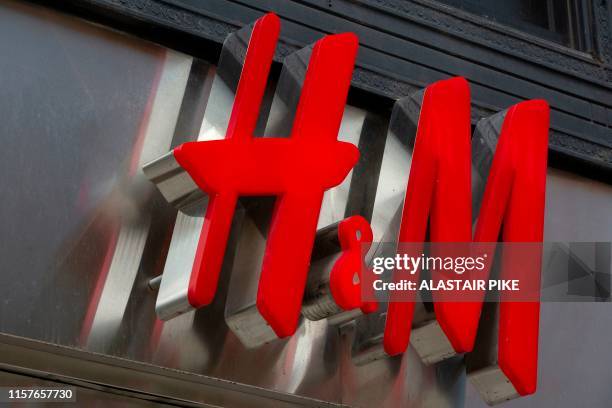 The H&M logo is seen outside a shop in Washington, DC, on July 25, 2019.