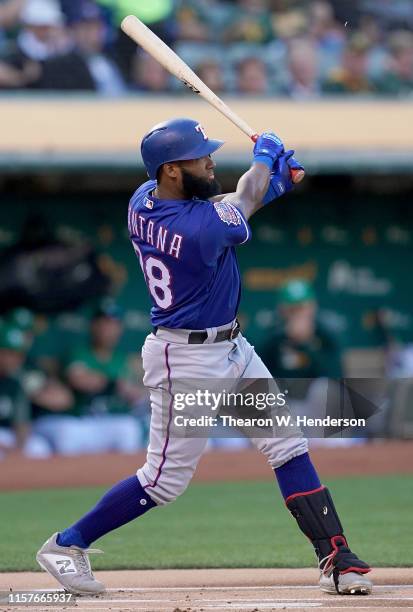 Danny Santana of the Texas Rangers hits a single against the Oakland Athletics in the top of the first inning at Ring Central Coliseum on July 25,...