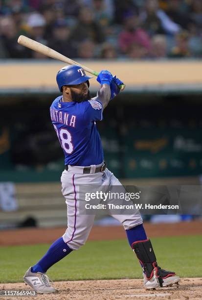 Danny Santana of the Texas Rangers hits a base loaded two-run rbi double against the Oakland Athletics in the top of the fifth inning at Ring Central...