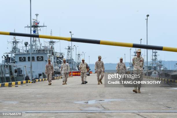 Cambodian navy personnel walk on a jetty in Ream naval base in Preah Sihanouk province during a government organized media tour on July 26, 2019. -...