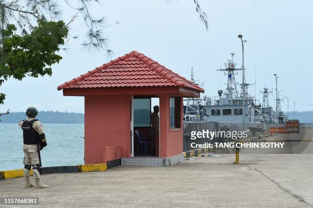 Cambodian navy personnel guard a jetty in Ream naval base in Preah Sihanouk province during a government organized media tour on July 26, 2019. -...