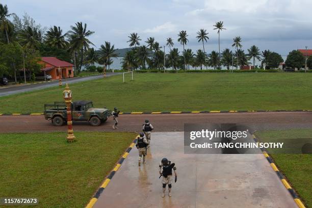 Cambodia naval personnel walk on the ground during a government organised media tour to the Ream naval base in Preah Sihanouk province on July 26,...