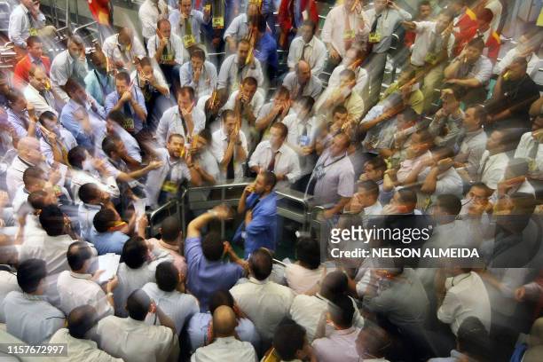 Stock traders negotiate in the future dollar pit during the second session, at the Mercantile & Futures Exchange , in Sao Paulo, Brazil, on April 15,...