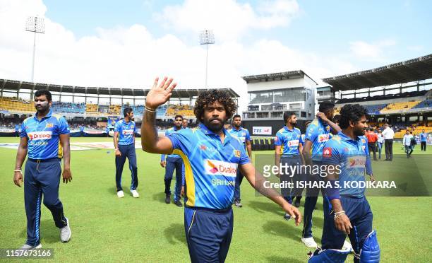 Sri Lankan cricketer Lasith Malinga waves to supporters during the first One Day International cricket match between Sri Lanka and Bangladesh at the...