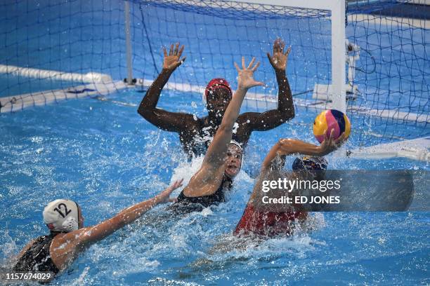 Spain's Maria Pena Carrasco throws the ball as USA's goalkeeper Ashleigh Johnson moves to block it during the women's final match between USA and...