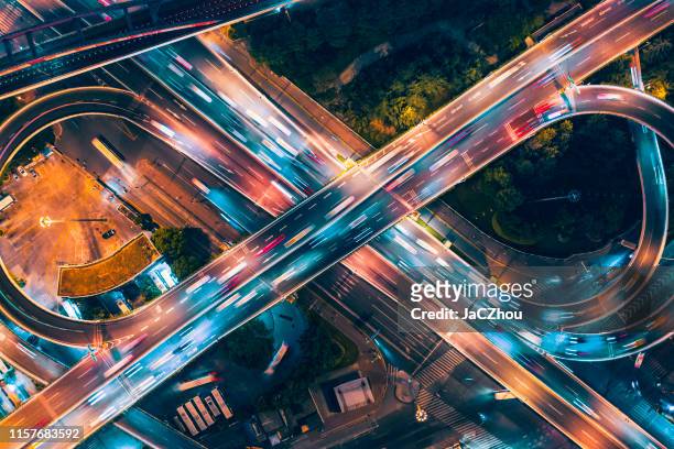 aerial view of overpass at night - road intersection stock pictures, royalty-free photos & images