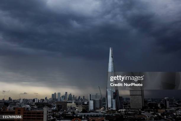 View of The Shard and Canary Wharfs skyline as the sky is cloudy, London on July 26, 2019. Yesterday was the second hottest day ever recorded in the...