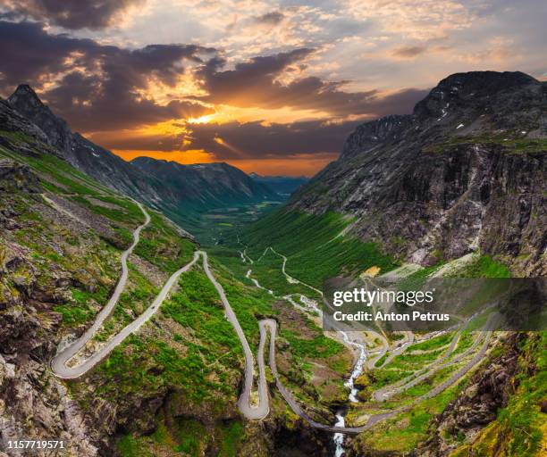 trollstigen or trolls path is a serpentine mountain road at sunset. rauma municipality in norway - troll fictional character stock pictures, royalty-free photos & images