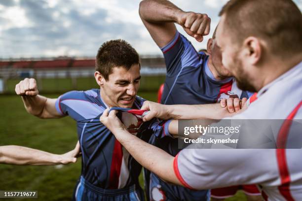 group of aggressive athletes having a fight o sports match. - rugby league field stock pictures, royalty-free photos & images