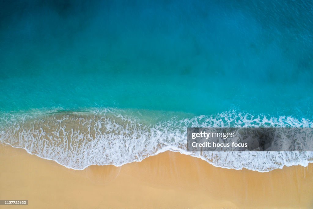 Aerial view of clear turquoise sea and waves