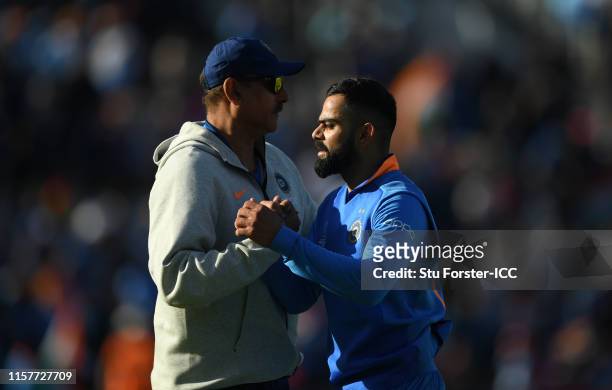India captain Virat Kohli is congratulated by coach Ravi Shastri after the Group Stage match of the ICC Cricket World Cup 2019 between India and...