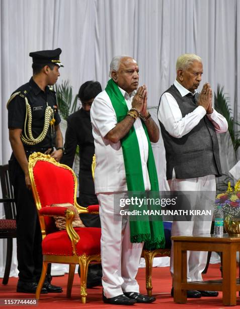 Governor of Karnataka, Vaju Bhai Valla , and senior leader of Bharatiya Janata Party , B.S. Yediyurappa , greet the gathering during Yediyurappa's...