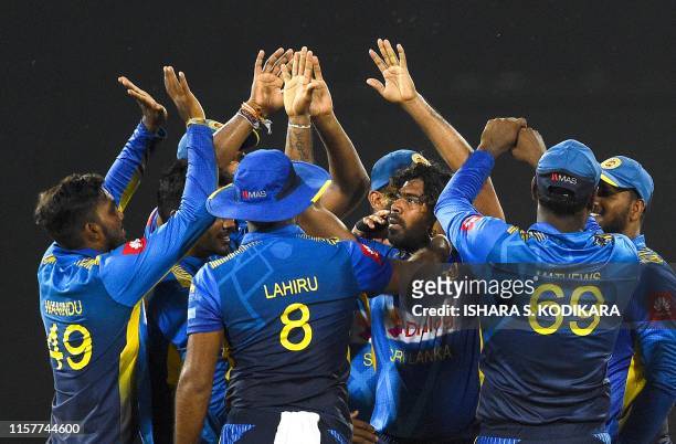 Sri Lankan cricketer Lasith Malinga celebrates with teammates after dismissing Bangladesh cricketer Soumya Sarkar during the first One Day...
