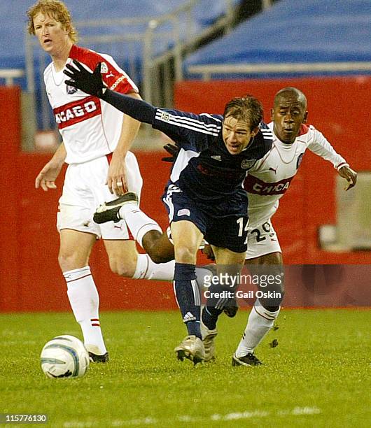 New England Revolution Steve Ralston, center, tries to get to the ball before Chicago Fire Thiago, right, Saturday, May 7 at Gillette Stadium in...