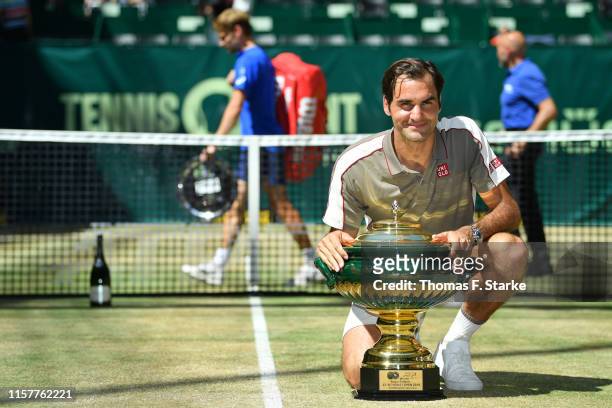 Roger Federer of Switzerland celebrates with the winners cup after winning the final match against David Goffin of Belgium during day 7 of the...