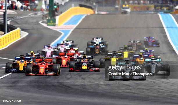 Lewis Hamilton of Great Britain driving the Mercedes AMG Petronas F1 Team Mercedes W10 leads the field into turn one at the start during the F1 Grand...