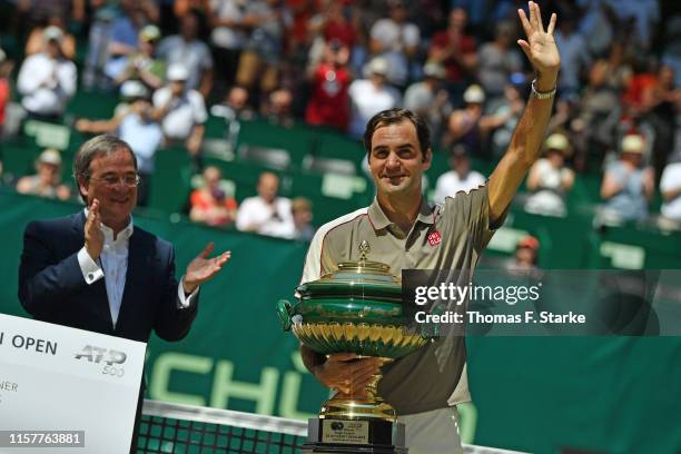 State Premier of North Rhine-Westphalia Armin Laschet applauds Roger Federer of Switzerland after winning the final match against David Goffin of...