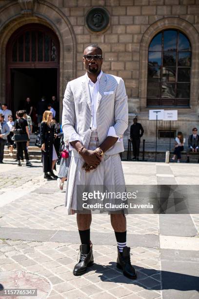 Serge Ibaka, wearing a black and white striped blazer with matching shorts, white shirt, black socks and black boots, is seen outside Thom Browne...