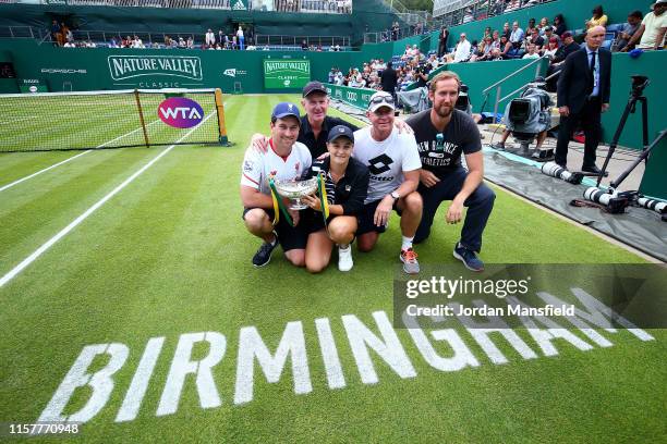 Ashleigh Barty of Australia poses for a photo with her team and the Maud Watson Trophy after victory in her final match against Julia Goerges of...