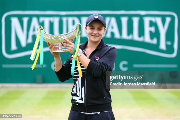 Ashleigh Barty of Australia lifts the Maud Watson Trophy after victory in her final match against Julia Goerges of Germany on day seven of the Nature...