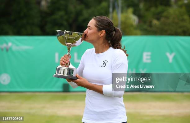 Monica Niculescu of Romania poses with the Ilkley Trophy after her victory over Timea Babos of Hungary during the Women's Final at Ilkley Lawn Tennis...