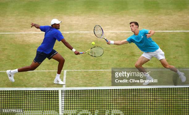 Rajeev Ram of The United States and partner Joe Salisbury of Great Britain return the ball during the mens doubles final against Andy Murray of Great...