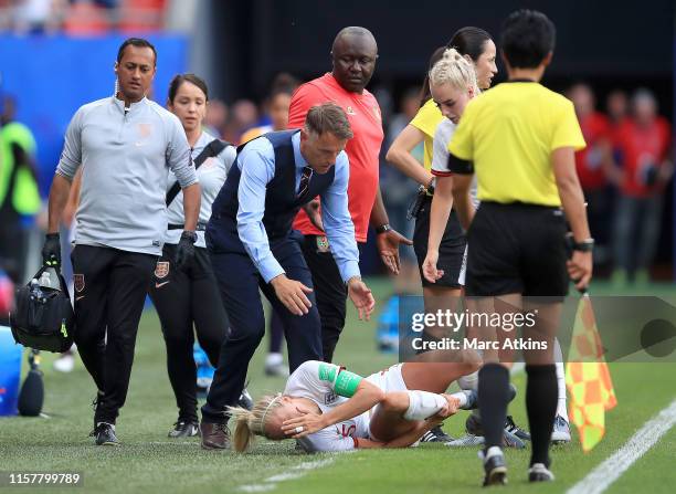 Steph Houghton of England reacts after she is fouled infront of Philip Neville, Head Coach of England and Alain Djeumfa, Head Coach of Cameroon...