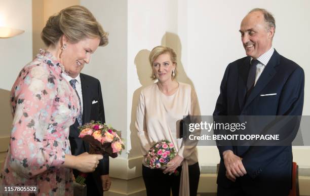 Queen Mathilde of Belgium passes by Princess Astrid and Prince Lorenz of Belgium ahead of a concert on the eve of Belgium's National Day, Saturday 20...