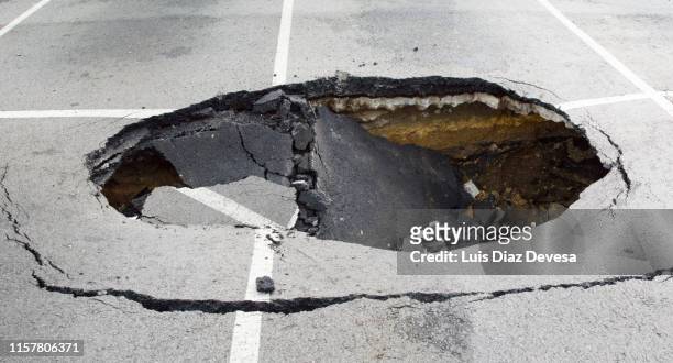 parking destroyed by the effects of rain - sinkhole stock pictures, royalty-free photos & images