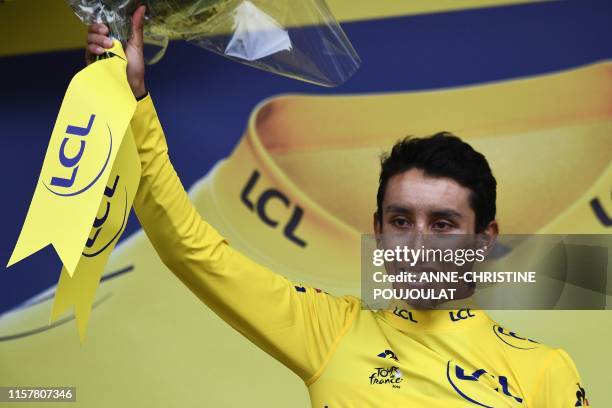 Colombia's Egan Bernal celebrates his overall leader's yellow jersey on the podium of the nineteenth stage of the 106th edition of the Tour de France...