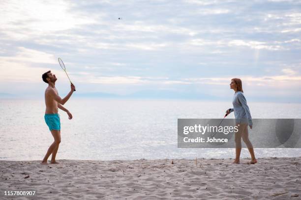 friends playing badminton - badminton strand stock pictures, royalty-free photos & images