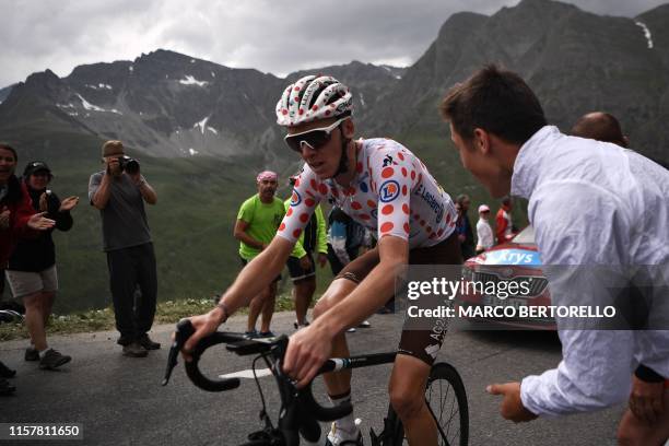 Fan cheers France's Romain Bardet, wearing the best climber's polka dot jersey riding uphill during the nineteenth stage of the 106th edition of the...