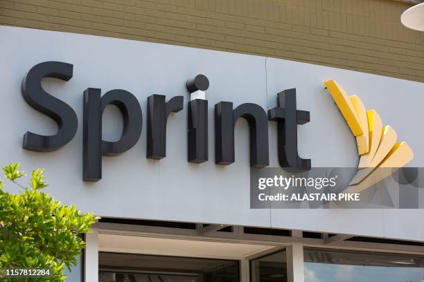 The Sprint logo is seen outside a shop in Washington, DC, on July 26, 2019. - US antitrust authorities approved the USD 26 billion merger of T-Mobile...