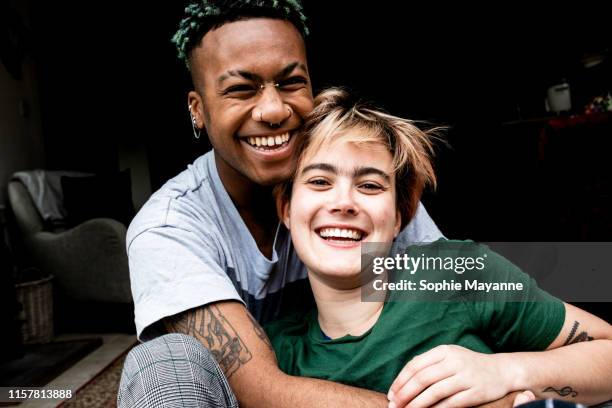 A young LGBT couple laughing and hugging