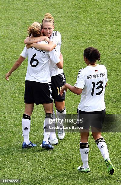 Simone Laudehr of germany celebrates with team mates Kim Kulig and Celia Okoyino da Mbabi after scoring his teams second goal during the Women's...