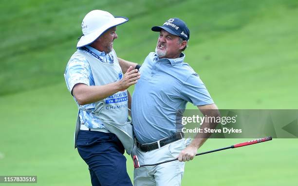 Jerry Kelly celebrates with his caddie after winning the American Family Insurance Championship in sudden death at the University Ridge Golf Course...