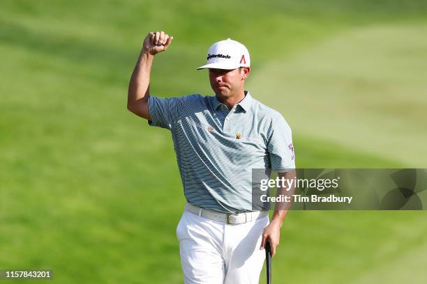 Chez Reavie of the United States celebrates on the 18th green after making a par to win the Travelers Championship at TPC River Highlands on June 23,...