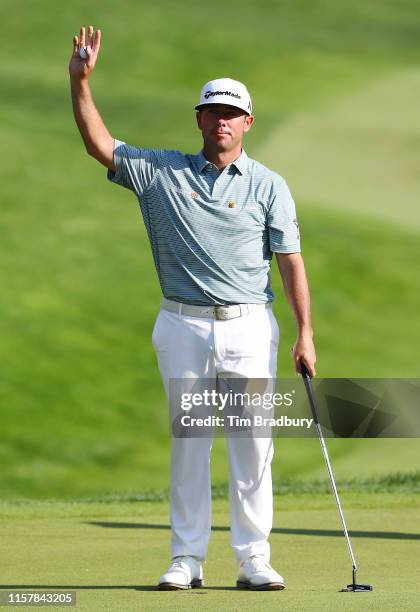Chez Reavie of the United States celebrates on the 18th green after making a par to win the Travelers Championship at TPC River Highlands on June 23,...