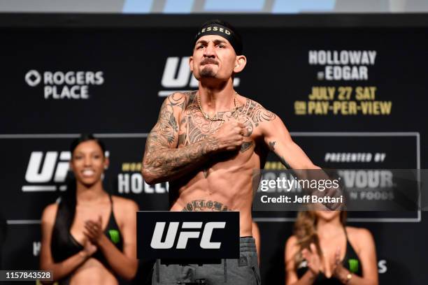 Max Holloway poses on the scale during the UFC 240 weigh-in at Rogers Place on July 26, 2019 in Edmonton, Alberta, Canada.