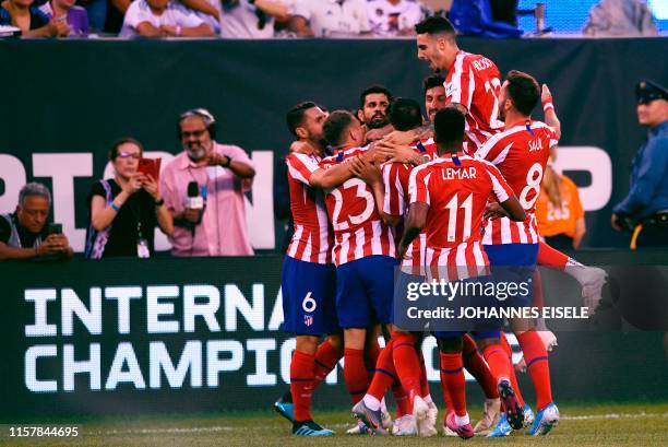 Atletico Madrid's Brazilian foward Diego Costa celebrates with teammates after scoring during their 2019 International Champions Cup football match...