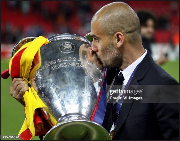 Josep Guardiola kissing the trophy during the UEFA Champions League final between FC Barcelona and Manchester United FC at Wembley Stadium on May 28,...